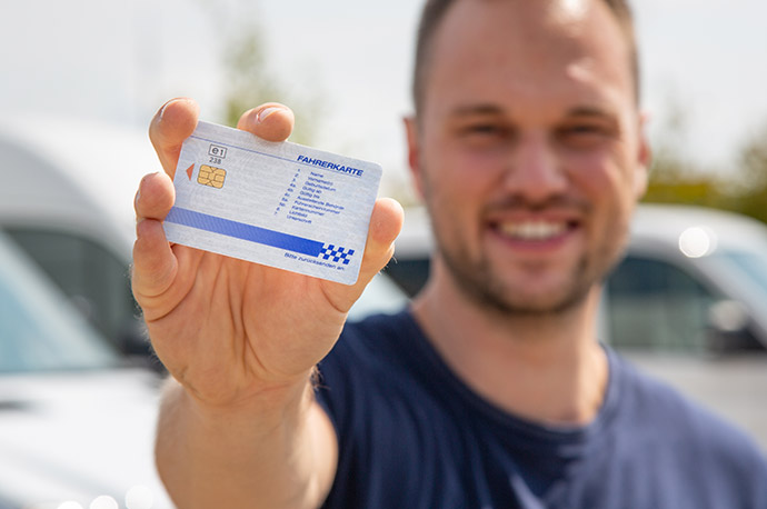 A man holds his gascard into the camera